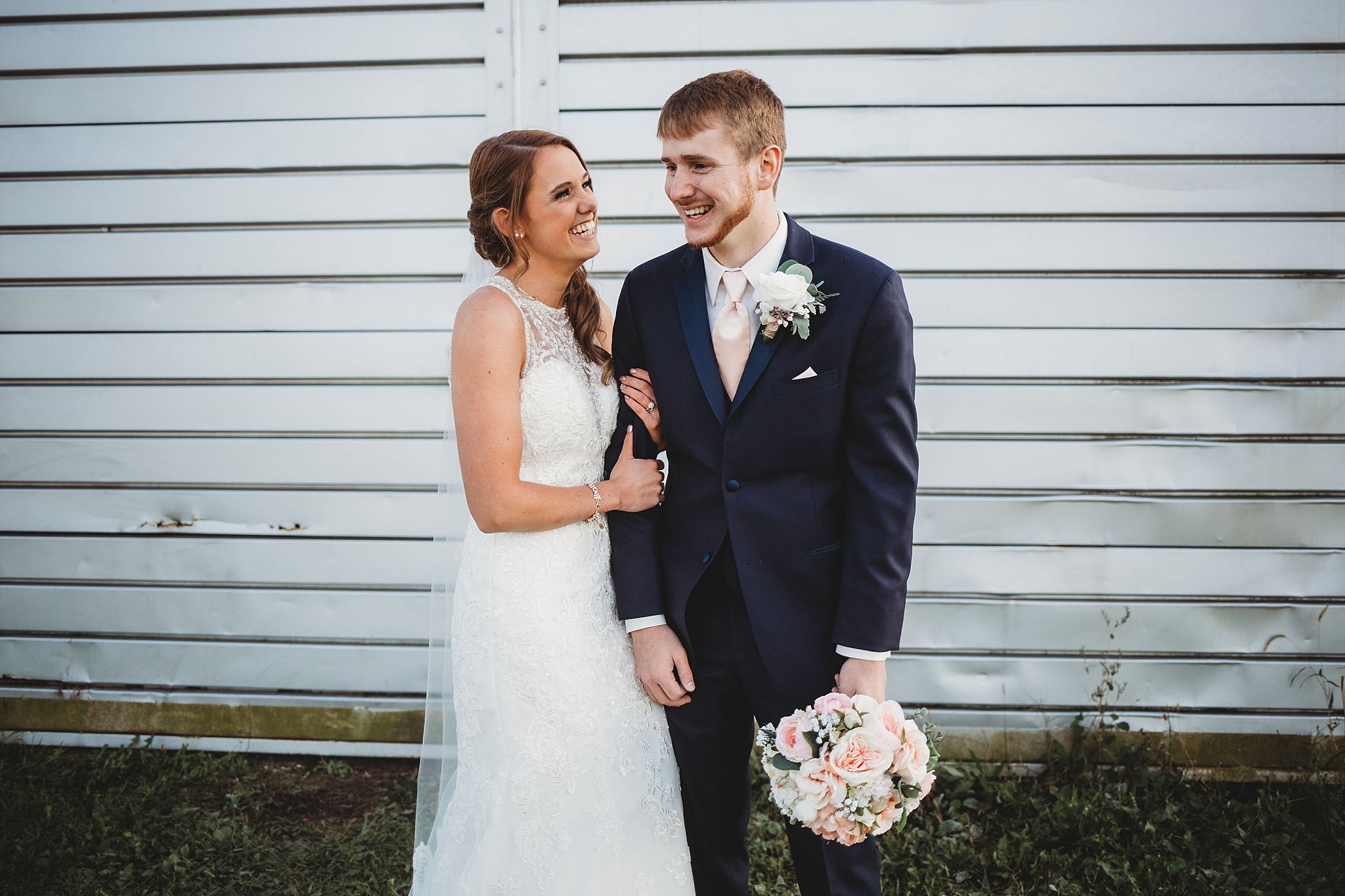bride and groom laughing at each other at their meadow springs manor wedding in Francesville, Indiana