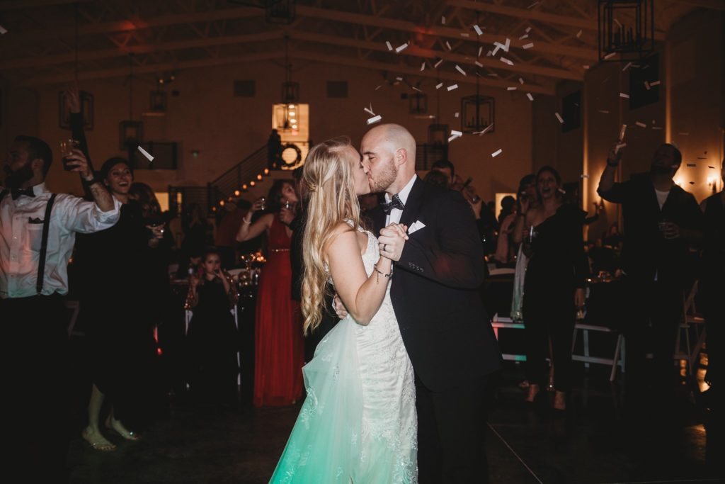couple sharing first kiss during indiana new years eve wedding 