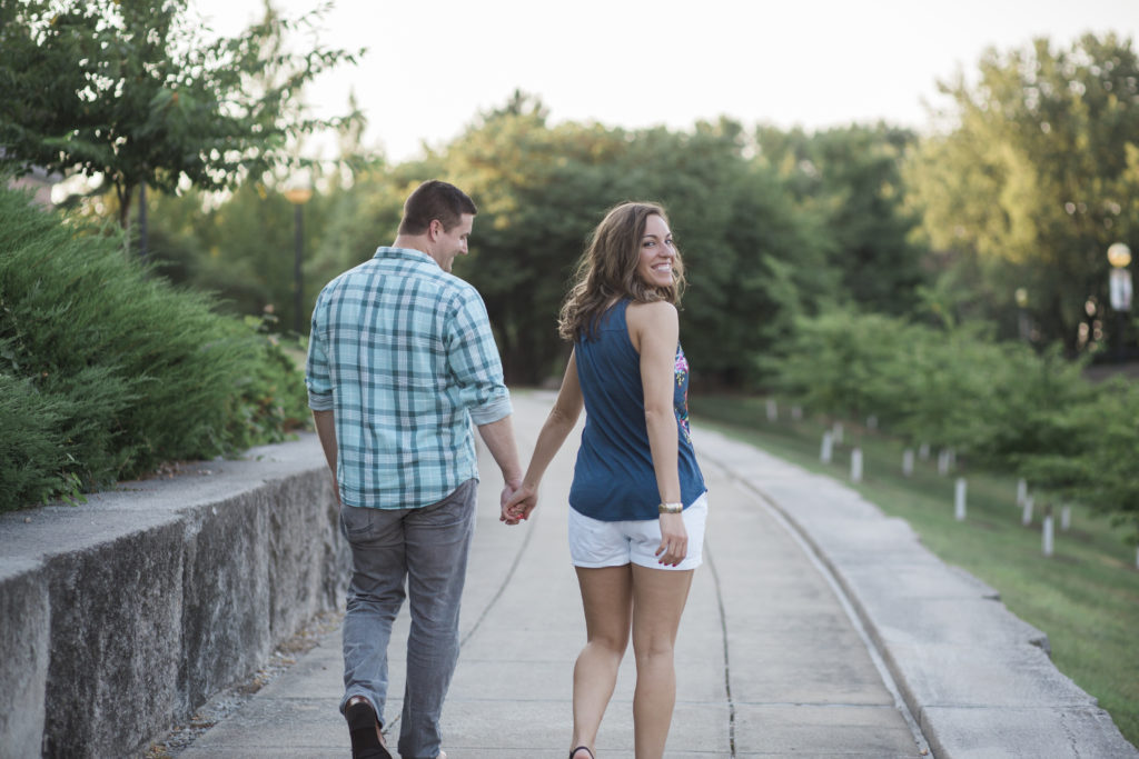 Romantic Places in Indianapolis To Propose- Engaged Couple walking hand in hand at the Indianapolis Zoo