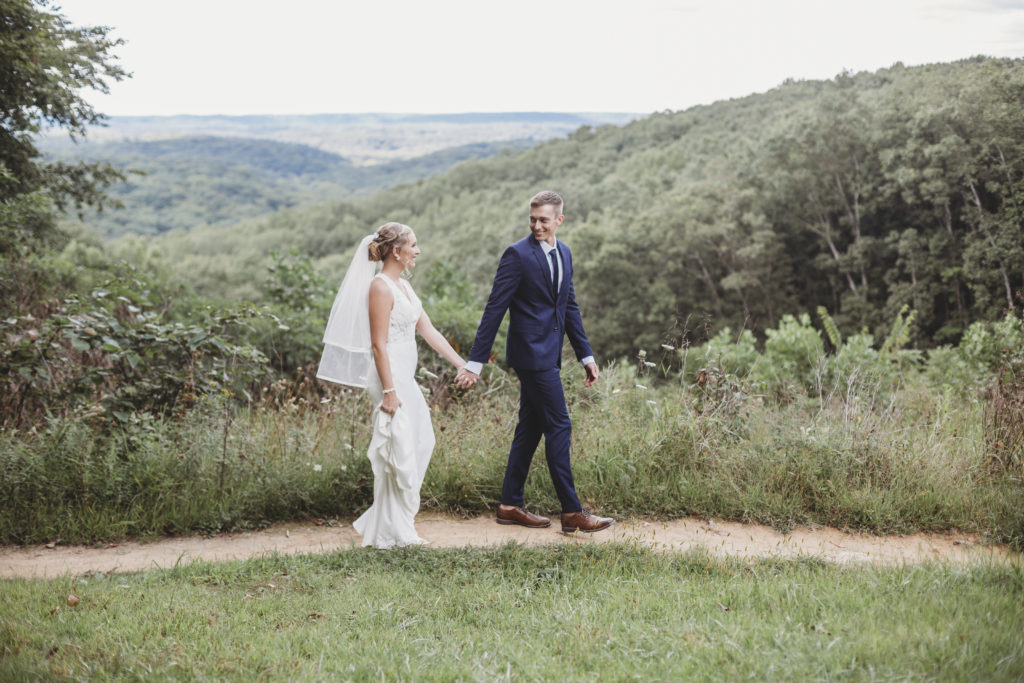 10 Reasons You Should Elope in the Midwest - Bride leads her groom through a path at Brown County State Park in Indiana. 