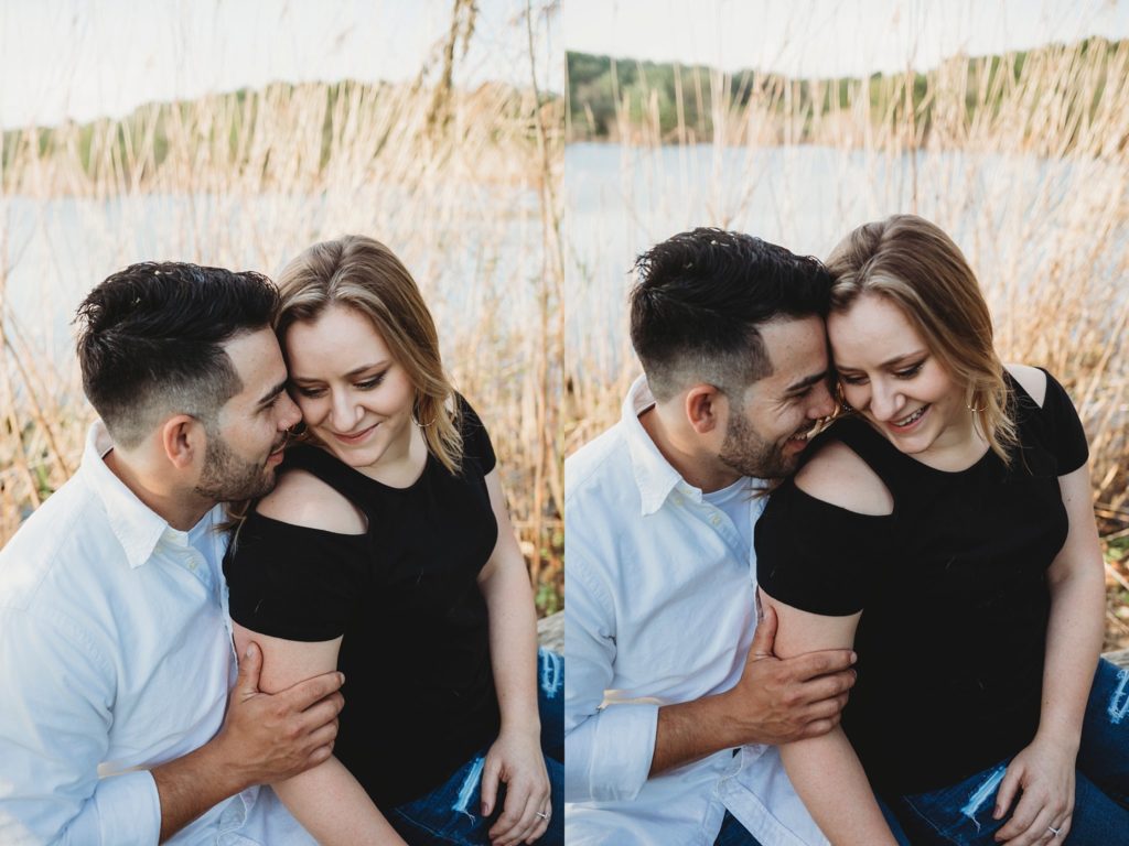 man and woman hold each other tight and take romantic engagement photos at Fairfield Lakes Park during sunset
