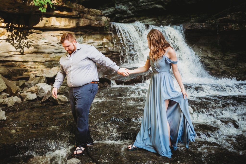 Best Waterfalls in Indiana- Man and woman walking away from McCormick's Creek Falls in Spencer, Indiana 