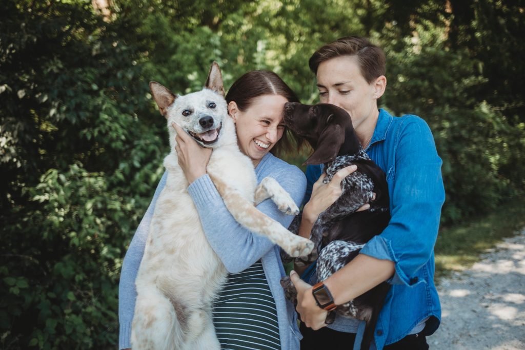 LGBTQ couple holding their dogs and getting kisses at their Lafayette, Indiana couples session 