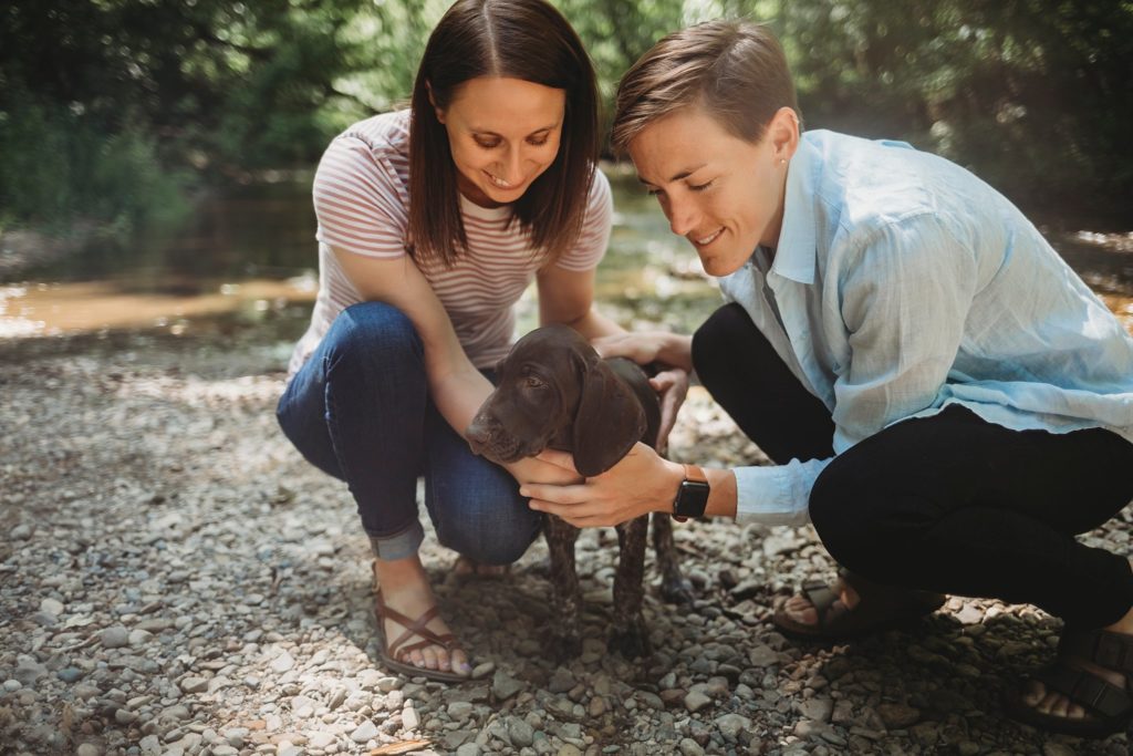 LGBTQ couple petting their puppy at their Lafayette, Indiana couples session 