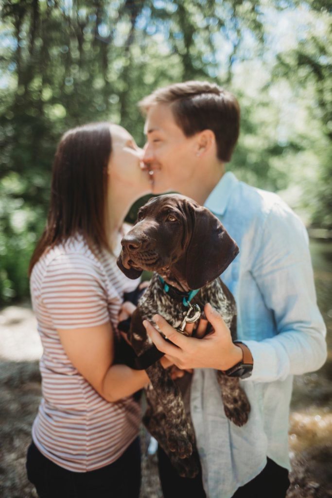 How To Pick A Location For Your Engagement Session// LGBTQ couple kissing while holding onto their new puppy in Indianapolis, Indiana