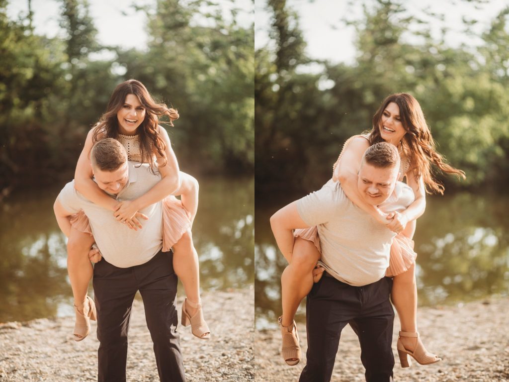 Fairfield Lakes Park Engagement Session- Man giving woman a piggy back ride near water in Lafayette Indiana at Fairfield lakes park.