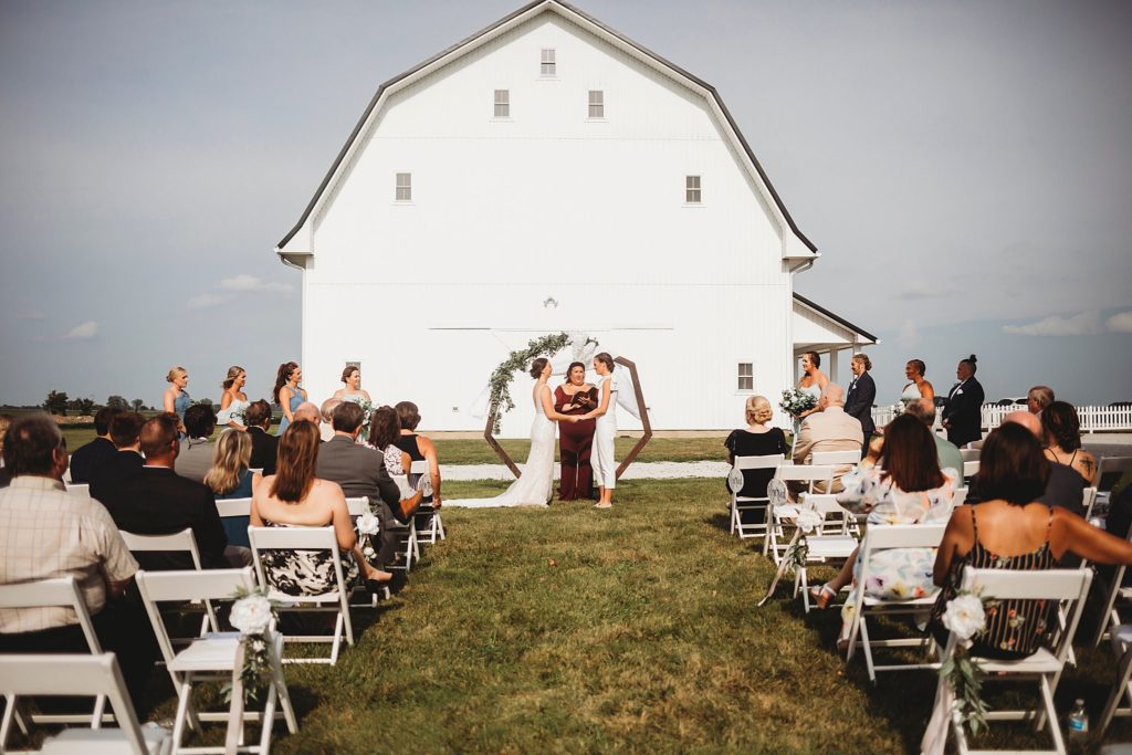 Top Elopement Locations in Central Indiana- woman and woman exchanging vows at their elopement at the gathering barn in bringhurst, indiana. 