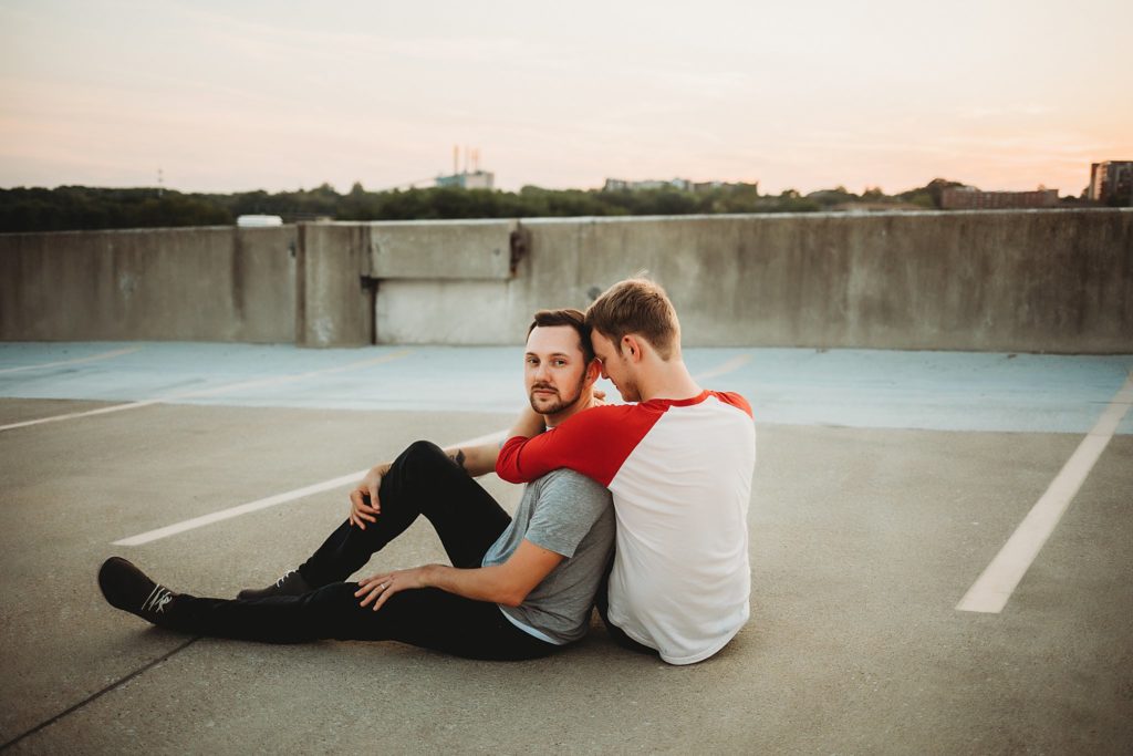 man wrapped around man sitting during their Indiana LGBTQ engagement session. 