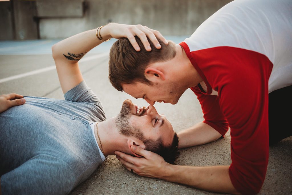 man leaning over man touching noses during their Indiana LGBTQ engagement session. 