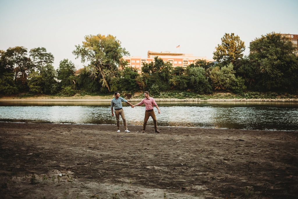 LGBTQ couple walking along the water during their Indiana LGBTQ engagement session. 