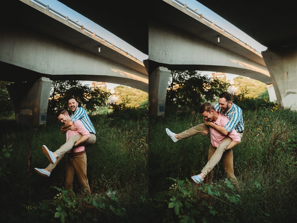 man giving man a piggy back ride during their Indiana LGBTQ engagement session. 