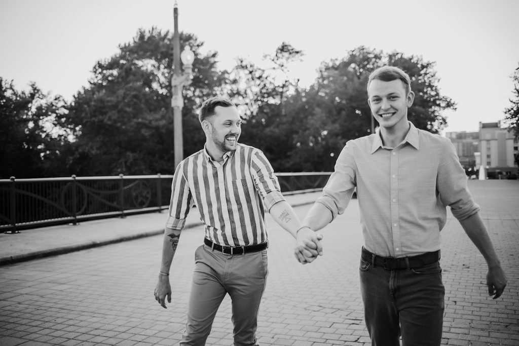 LGBTQ couple walking and swinging their arms during their Indiana LGBTQ engagement session. 