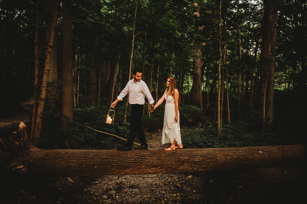 man and woman walking with a lantern during their Indianapolis Indiana Anniversary Session