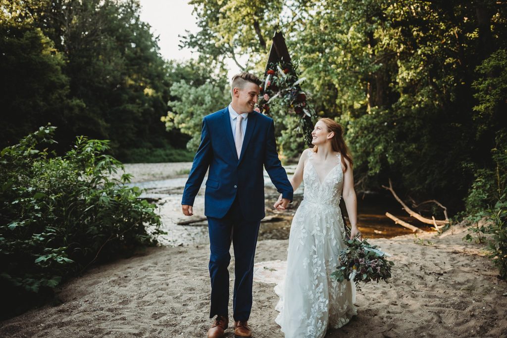 Indiana Elopement// Morgan + Kyle -  Groom and bride look at each other while walking towards the camera.