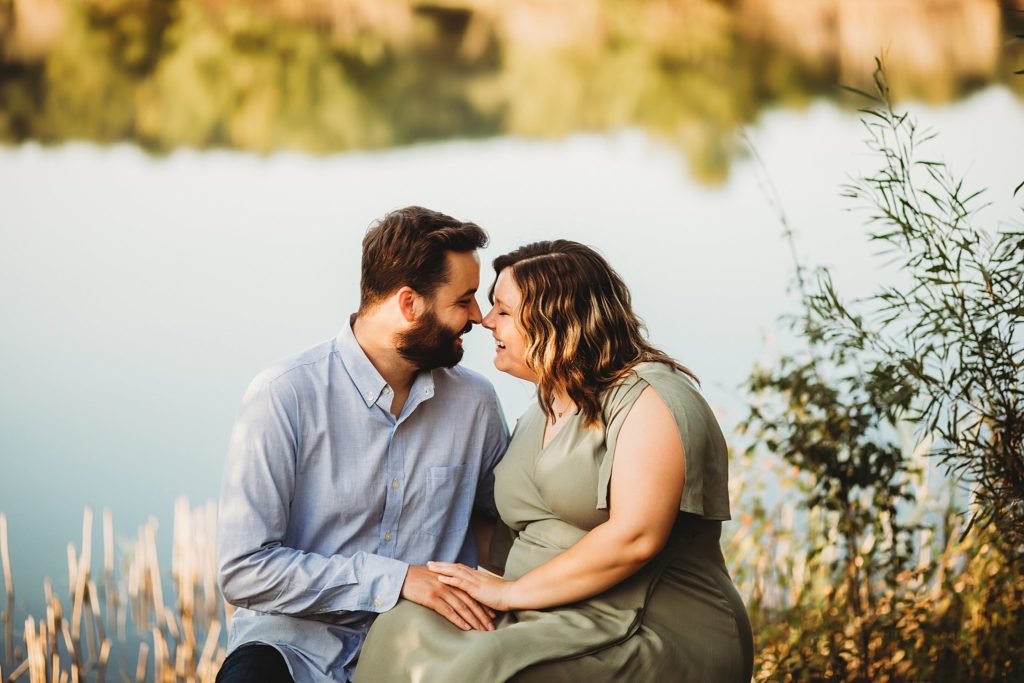 West Lafayette Indiana Couples Session// Evan + Abby - Couple sits together on a bench touching noses together with big smiles.