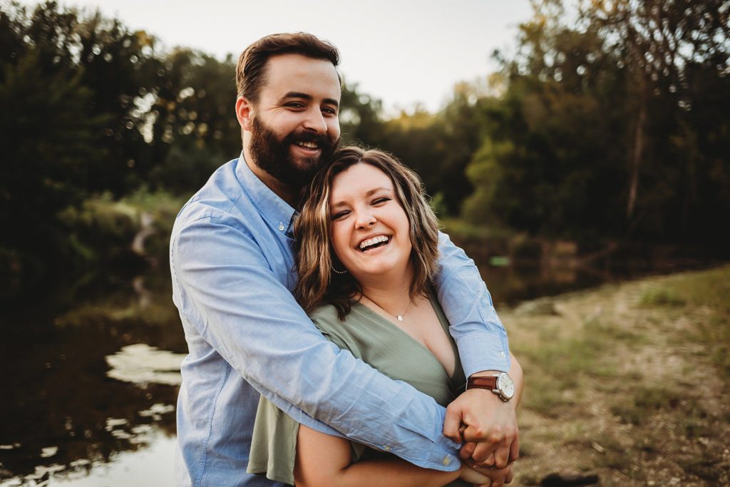 West Lafayette Indiana Couples Session// Evan + Abby - Man wraps arms around woman while they both smile at the camera. 