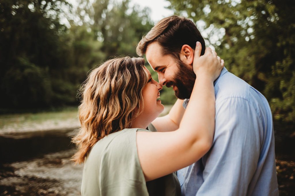 West Lafayette Indiana Couples Session// Evan + Abby - Woman has hands on the back of man's neck while couple smiles and touches noses together.