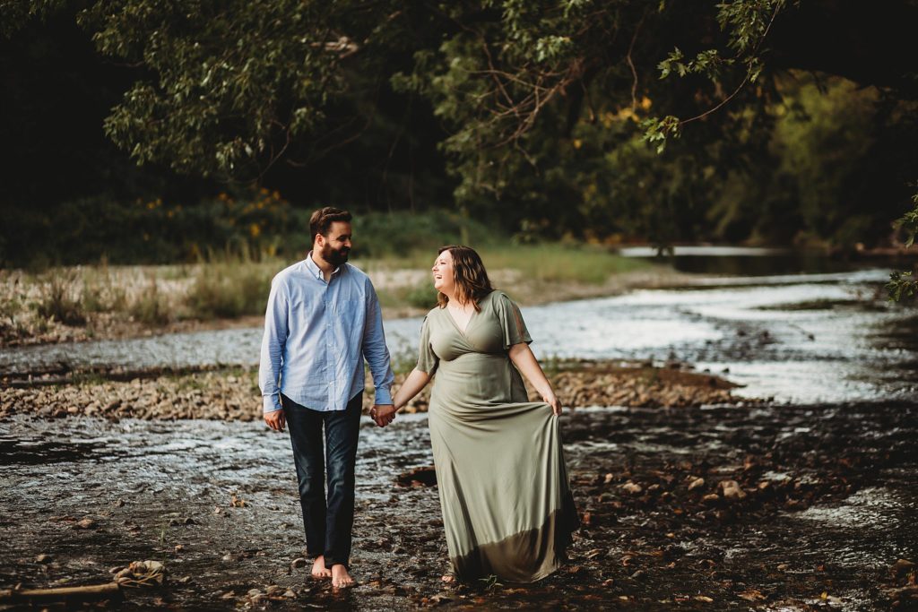 West Lafayette Indiana Couples Session// Evan + Abby - Couple walks hand in hand while looking at each other and walking towards the camera.