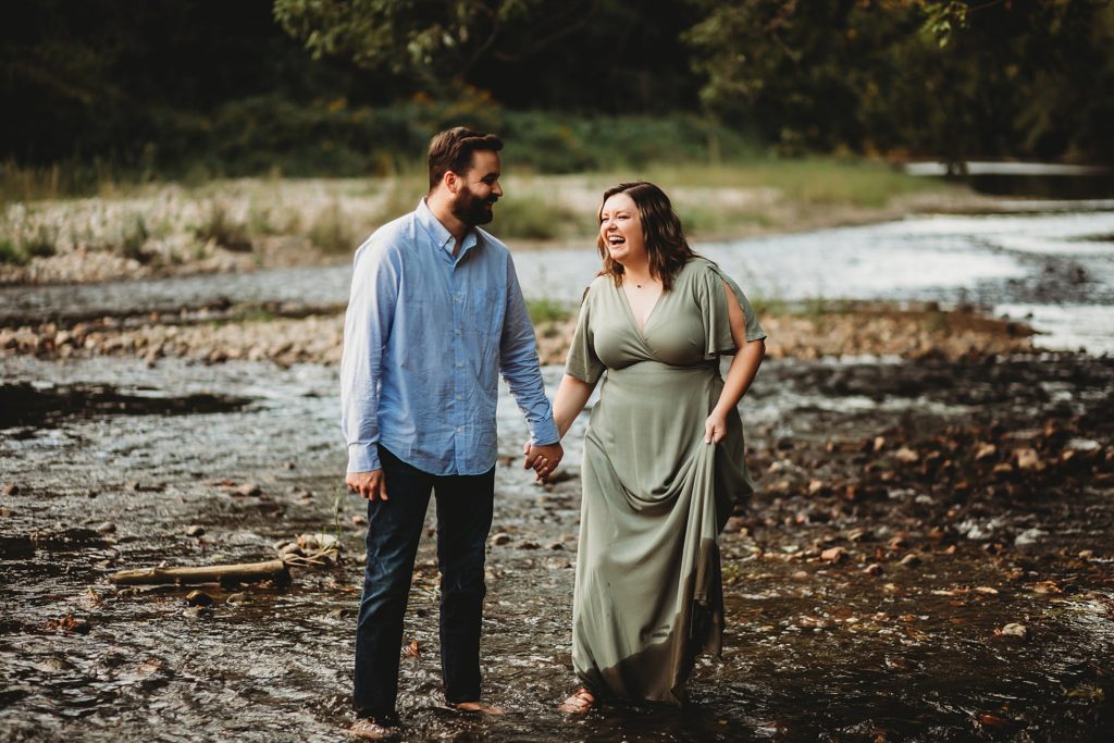 West Lafayette Indiana Couples Session// Evan + Abby - Couple walks in the rocky creek together laughing with each other.