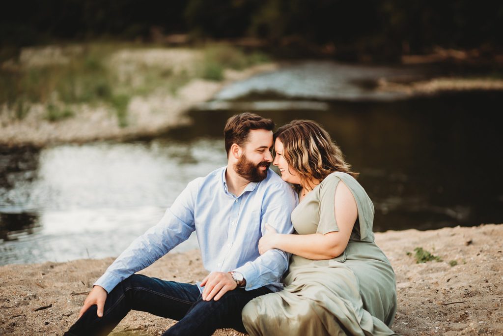 West Lafayette Indiana Couples Session// Evan + Abby - Couple sits on the sandy beach snuggling together, touching their noses together.