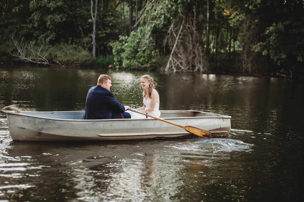 man and woman rowing a boat at Abram Farms, one of the outdoor Wedding Venues in Indiana