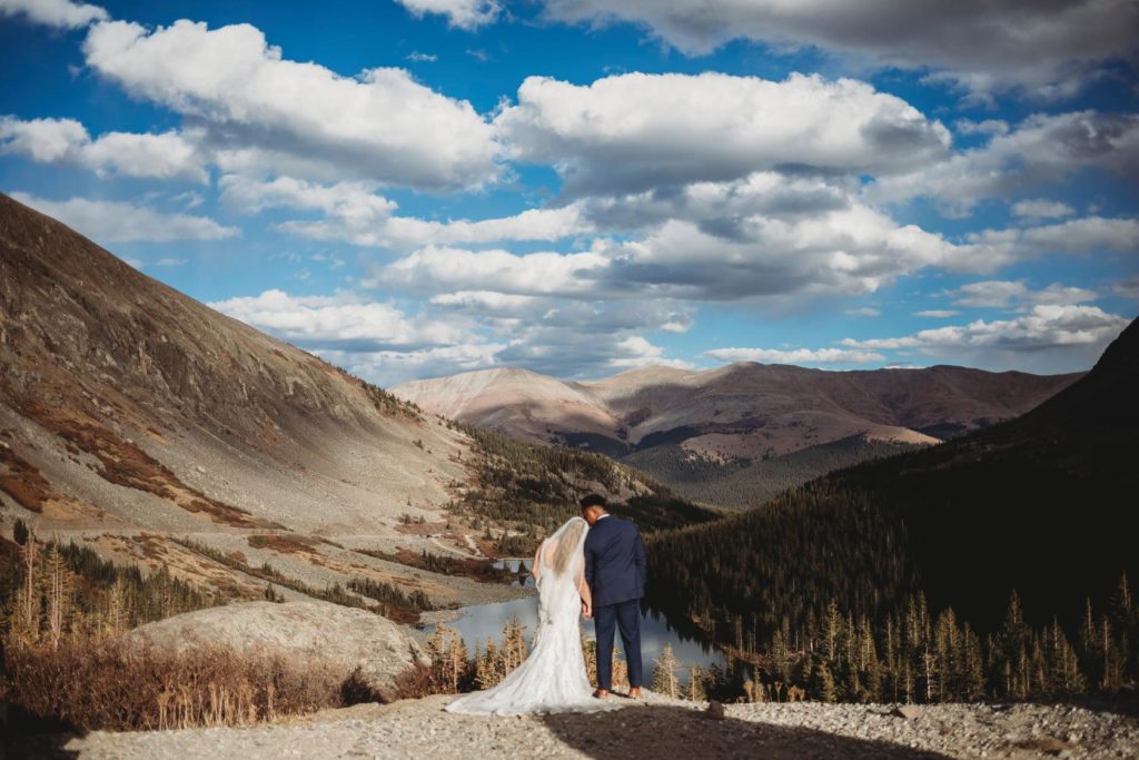 elopement trends for 2021- man and woman standing with their foreheads together while surrounded by tall trees in their breckenridge, colorado elopement 