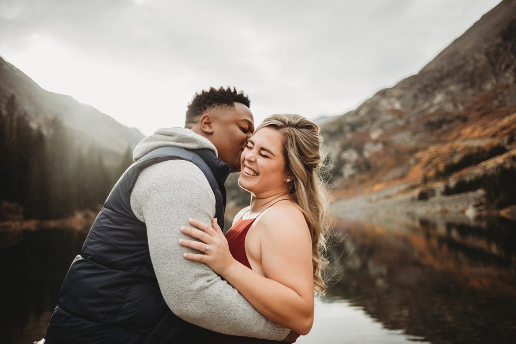 Breckenridge Engagement Session-couple kissing each other in breckenridge colorado