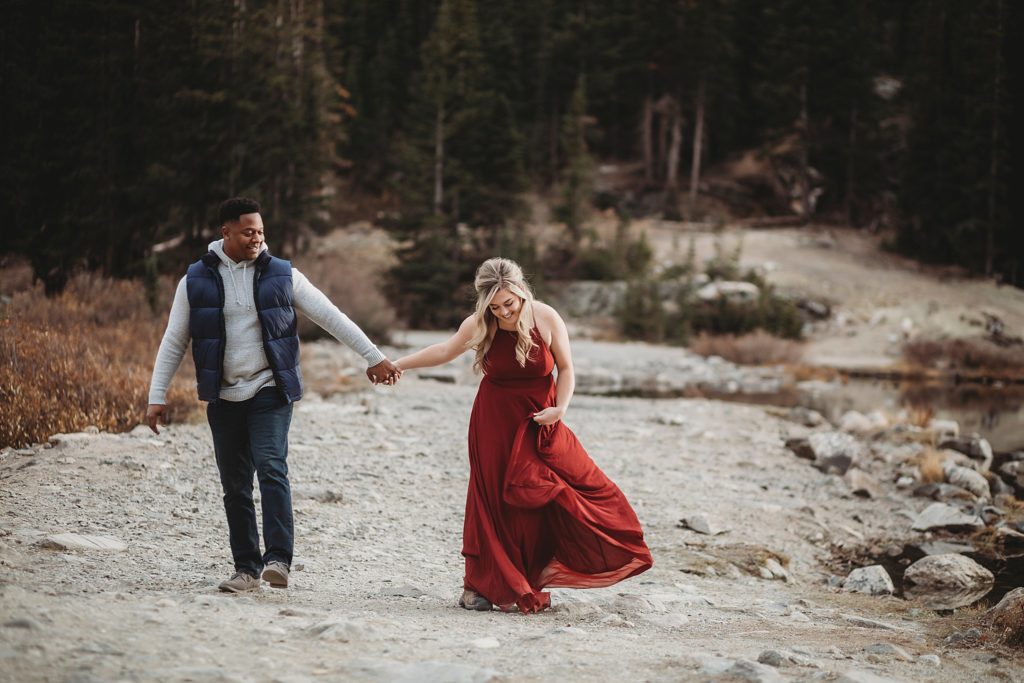 Breckenridge Engagement Session-couple walking along a trail looking at each other in breckenridge engagement session