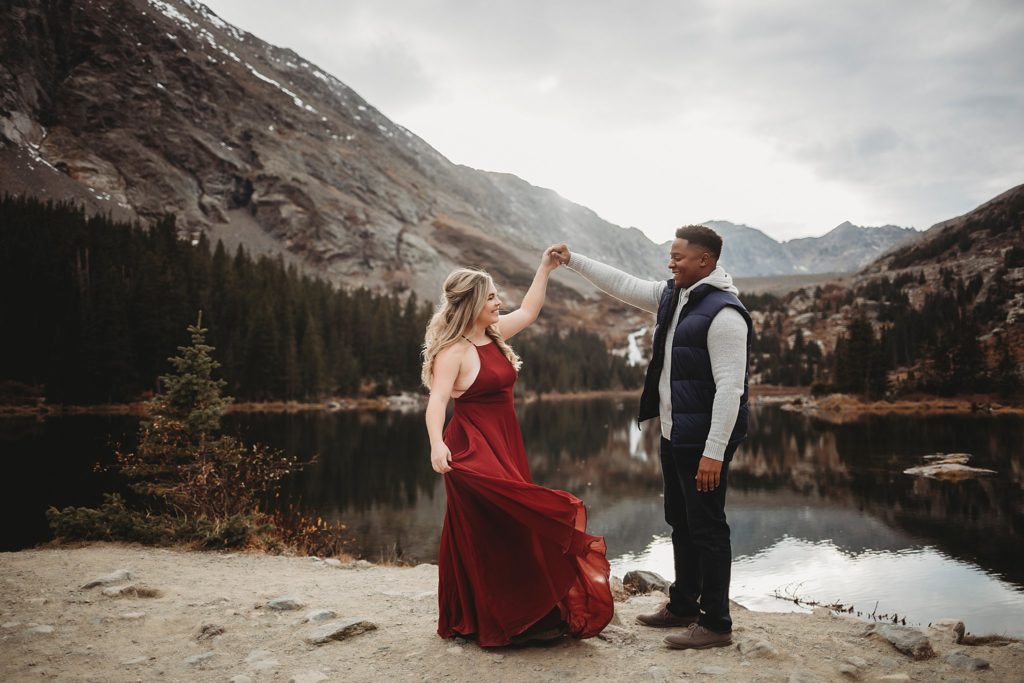 Breckenridge Engagement Session-couple dancing along a trail looking at each other in breckenridge engagement session