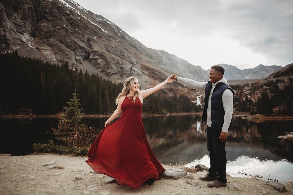 Breckenridge Engagement Session-couple dancing along a trail looking at each other in breckenridge engagement session