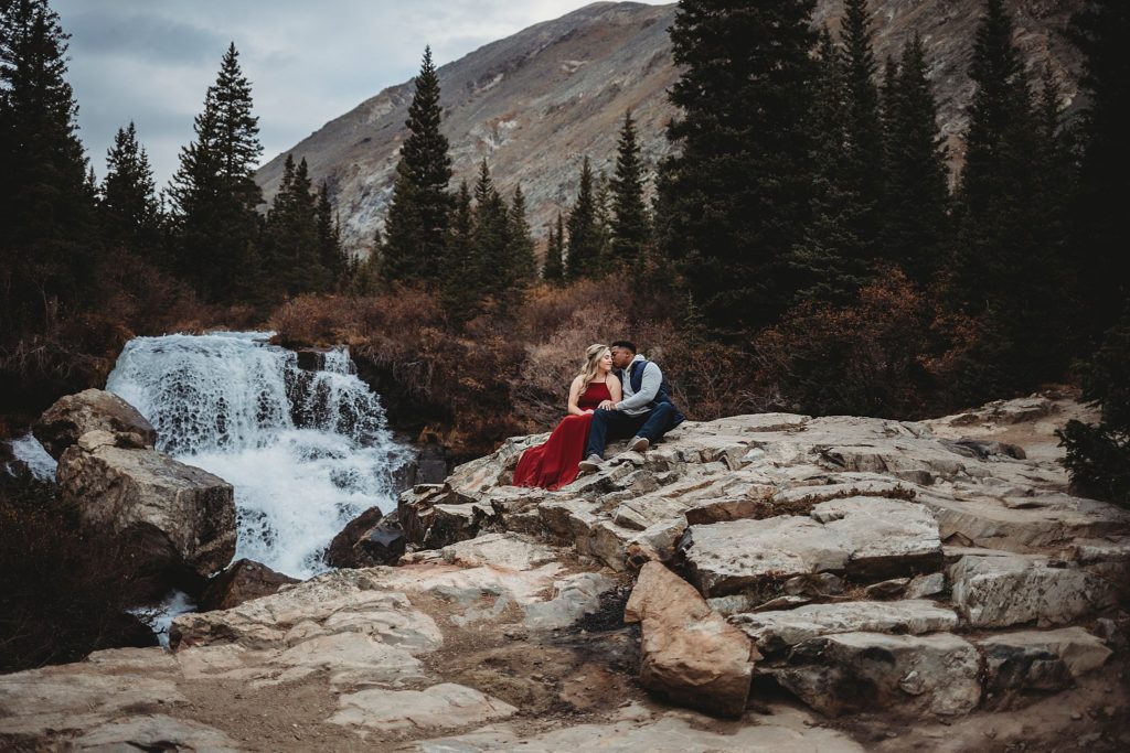 couple posing by waterfall