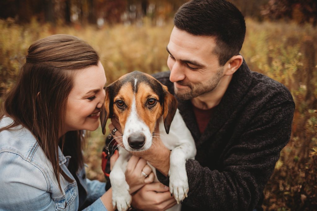 man and woman hug their dog at their West Lafayette Couples Session