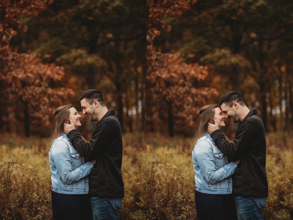 man and woman embrace in a park for their engagement pictures