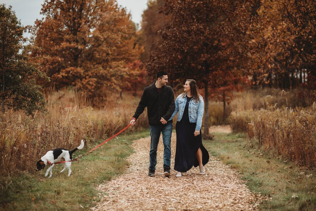 man and woman walking their dog for their West Lafayette Couples Session