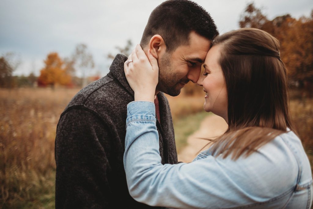 man and woman laughing while taking their engagement pictures