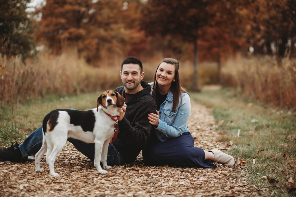 man woman and their dog sit on the ground for their West Lafayette Couples Session