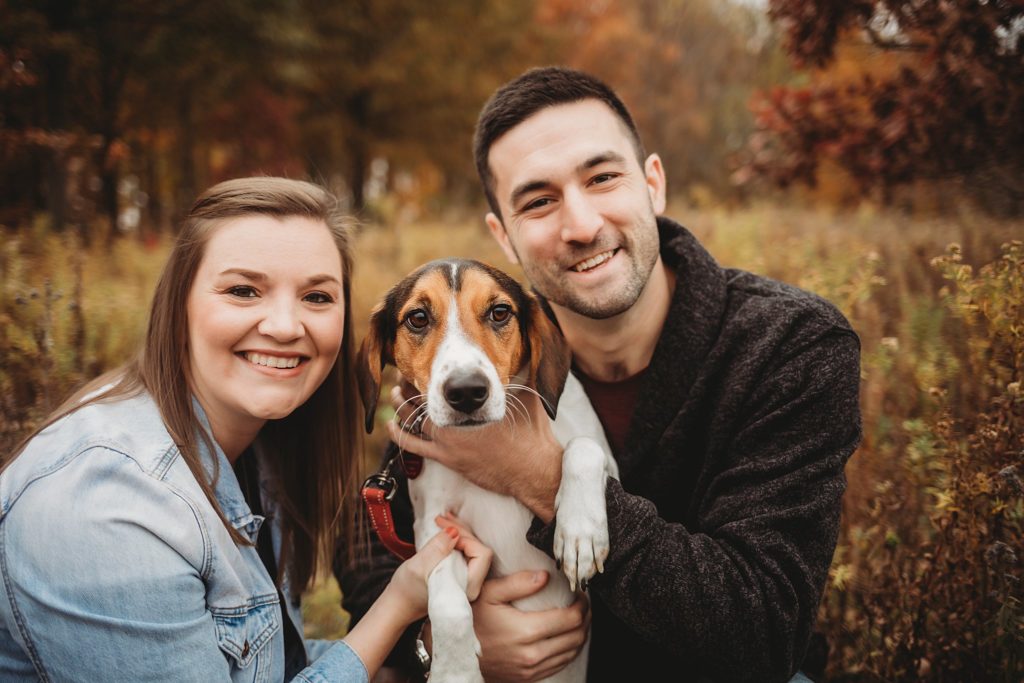 man woman and their dog smile for the camera at their West Lafayette Couples Session