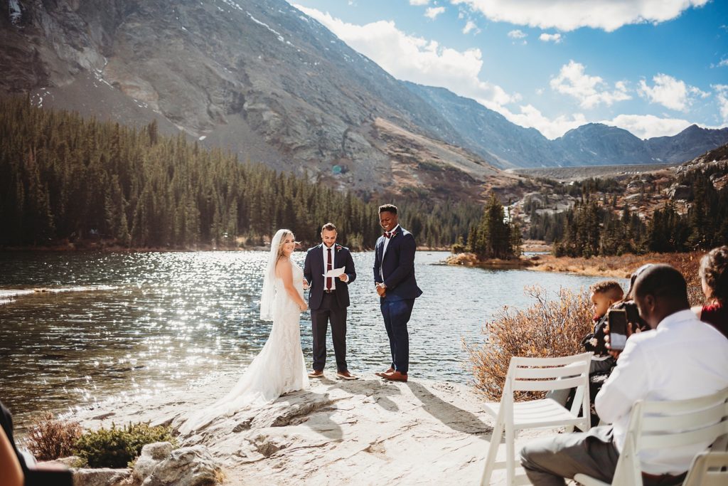 Bride and groom looking at guests at Blue Lakes in Breckenridge Colorado Elopement 