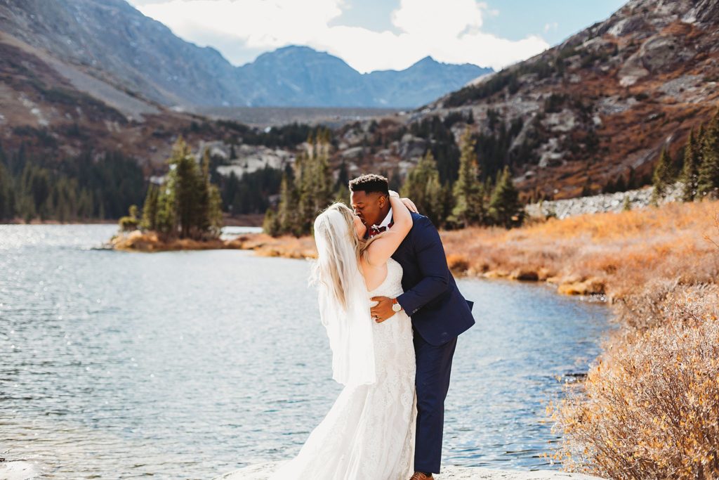 bride and groom during first kiss at their wedding at Blue Lakes in Breckenridge Colorado Elopement 