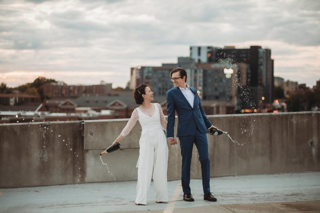 bride and groom pop champagne for elopement pictures in Indiana