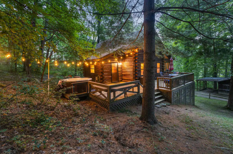 Cozy Pine cabin in Columbus Indiana surrounded by woods and twinkle lights to set the mood.