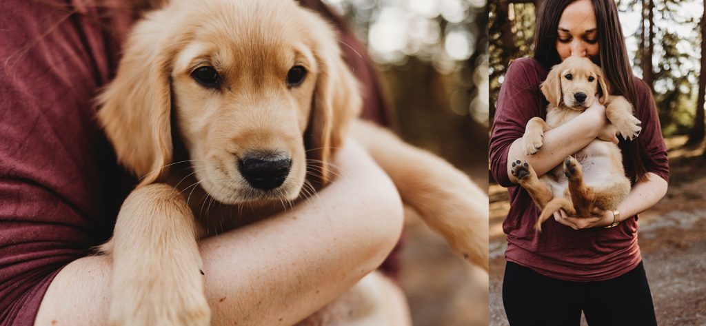 Girl in red shirt holding golden puppy in arms at Purdue horticulture park.