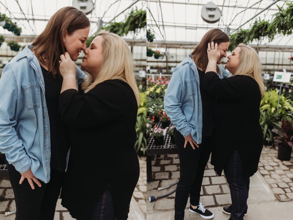 couple preparing to kiss while standing in the middle of the indiana green house