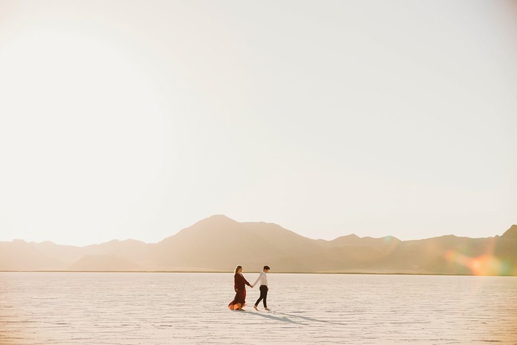 A couple walking at their Bonneville Salt Flats Wedding during sunset