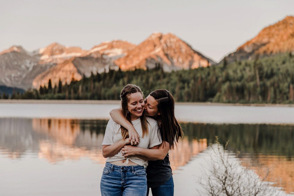two LGBTQ women holding onto one another at American Fork Canyon in Utah 