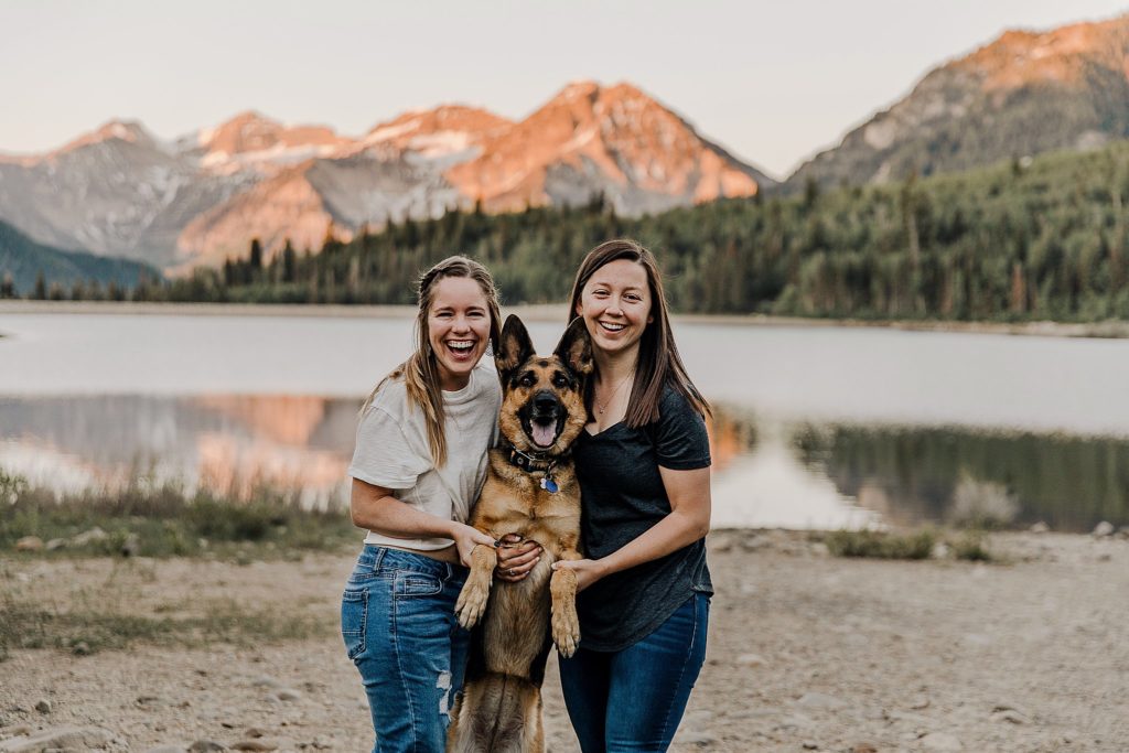 two women holding onto a german Shepard at the LGBTQ anniversary session in Utah 