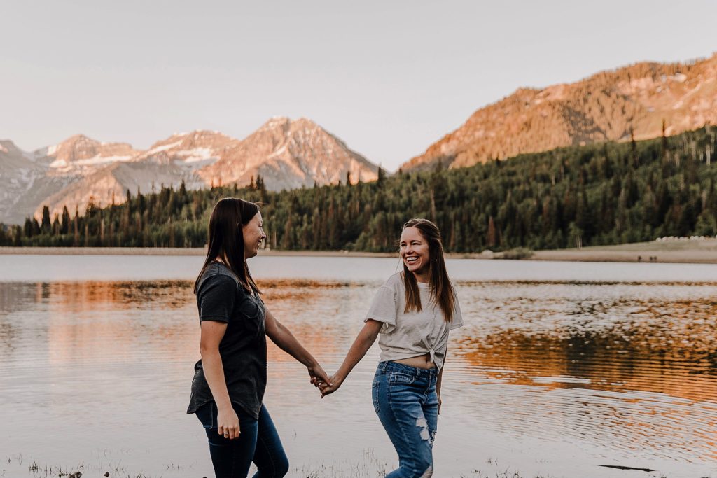 Two women walking together with mountains in the background at their american fork canyon anniversary session