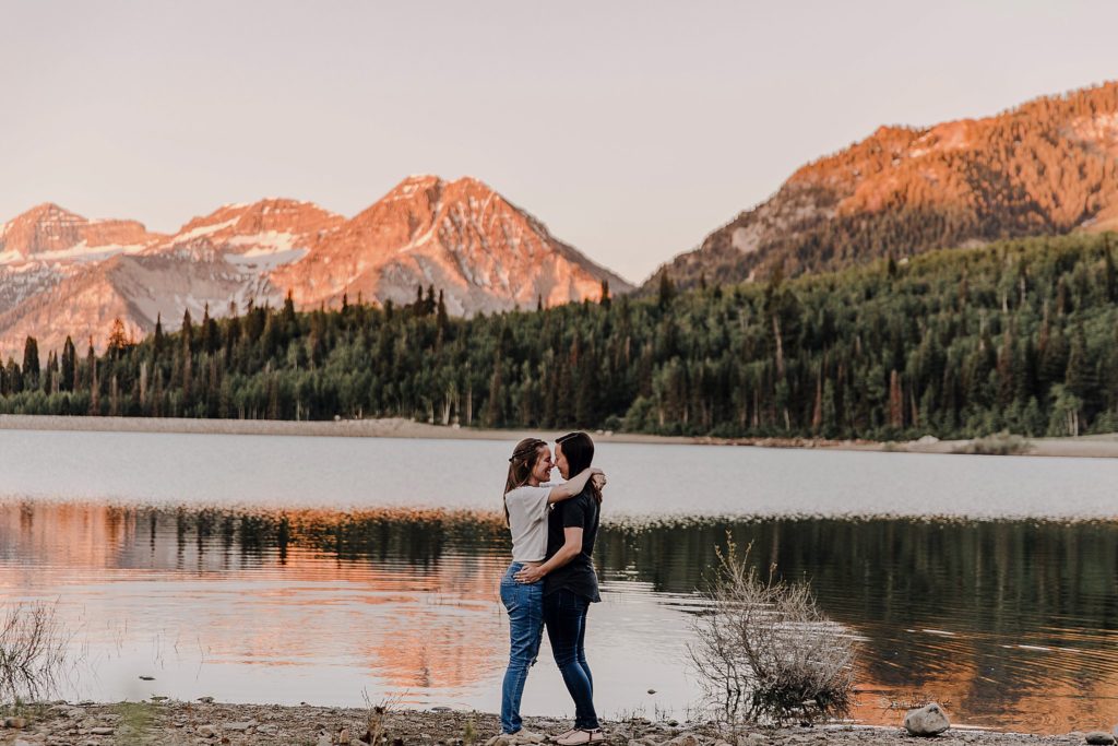 Two women holding hands overlooking the mountains at an LGBTQ anniversary session in Utah