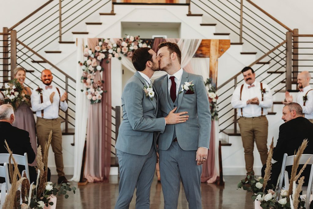 man and man kissing for the first time at their New Journey Farms Wedding in Lafayette, Indiana