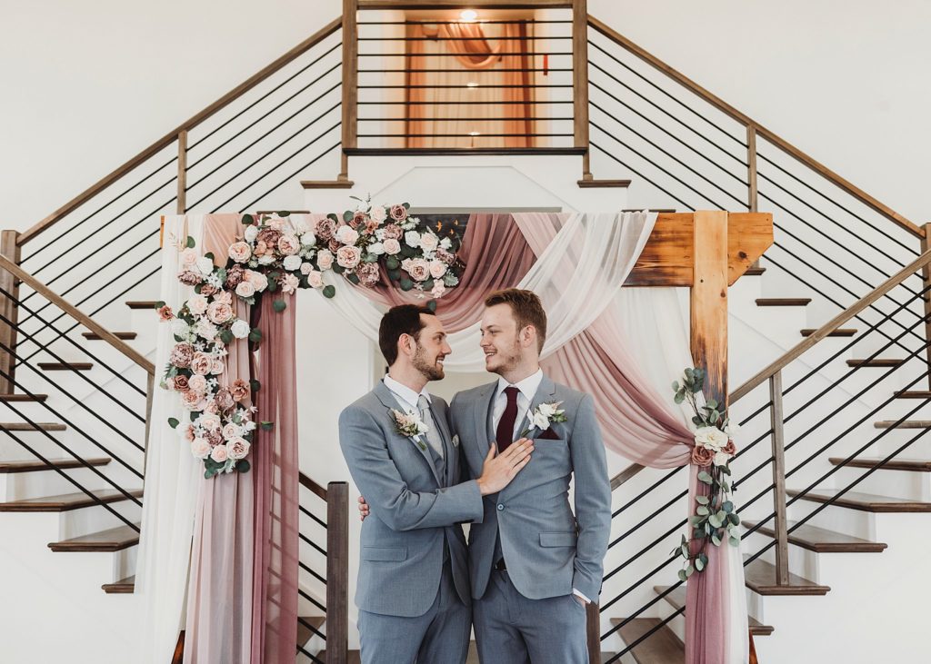 man and man looking into one anothers eyes at their New Journey Farms Wedding in Lafayette, Indiana